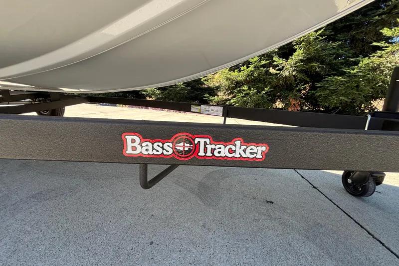 Slide: The Image of 2026 Tracker Bass Tracker Classic XL trailer with logo, parked on concrete surface. - 28