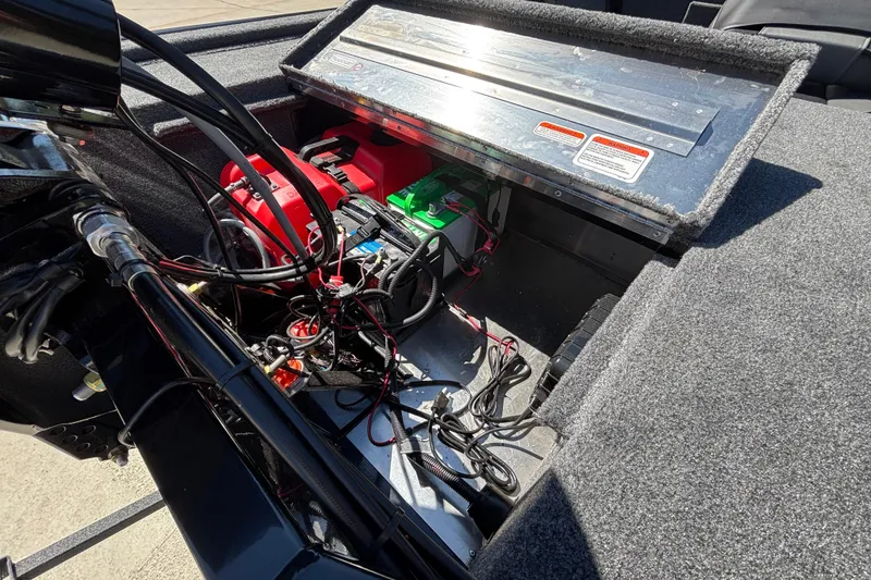 Slide: The Image of 2026 Tracker Bass Tracker Classic XL boat battery compartment with wiring and components. - 19