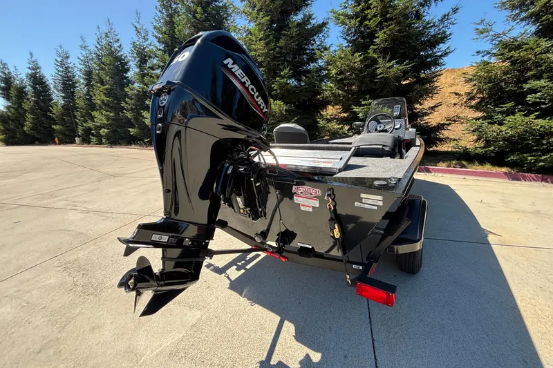 Slide: The Image of 2026 Tracker Bass Tracker Classic XL boat with Mercury outboard motor, parked outdoors. - 17