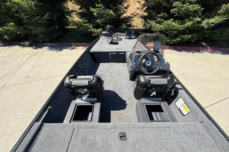 Slide: The Image of 2026 Tracker Bass Tracker Classic XL boat interior with steering console and seating. - 18