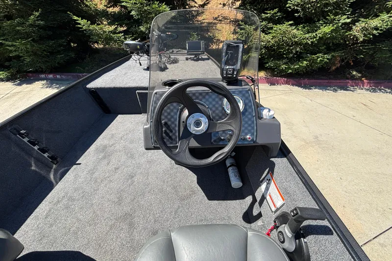 Slide: The Image of 2026 Tracker Bass Tracker Classic XL boat interior with steering wheel and control panel. - 22