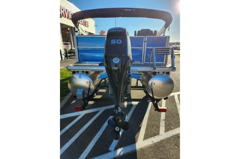 Slide: The Image of 2026 Sun Tracker Party Barge 16 DLX pontoon boat with 50 HP engine, rear view. - 2