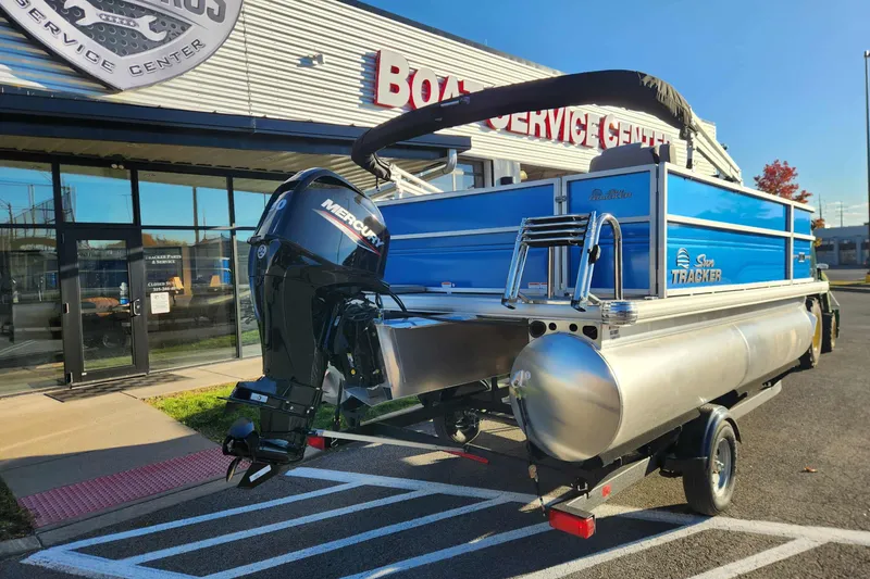 Slide: The Image of 2026 Sun Tracker Party Barge 16 DLX pontoon boat outside service center. - 5