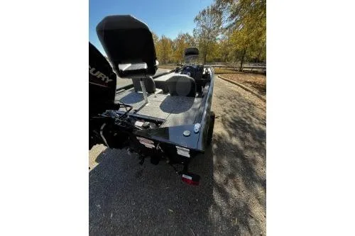 Slide: The Image of 2026 Tracker Pro 170 boat parked on a sunny day, showcasing seating and motor. - 4