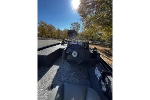 Slide: The Image of 2026 Tracker Pro 170 boat interior with steering wheel, under sunny sky. - 5