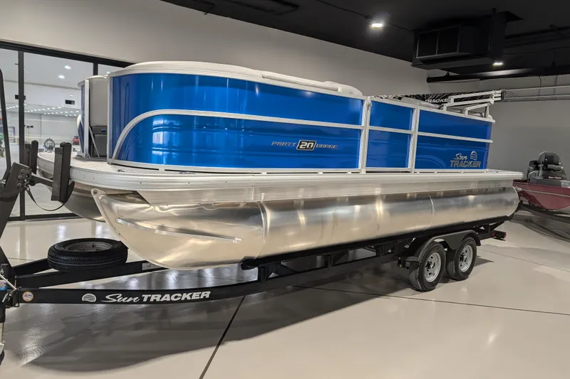 The Image of 2026 Sun Tracker Party Barge 20 DLX pontoon boat on trailer in showroom. - 67