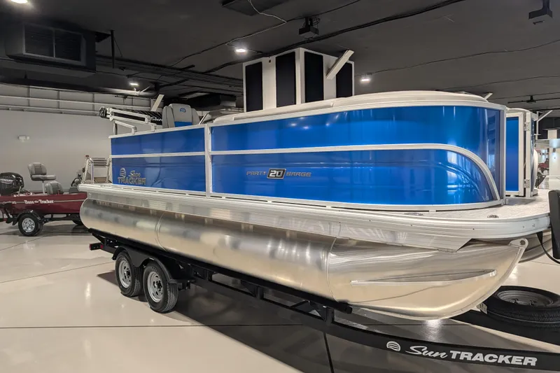 Slide: The Image of 2026 Sun Tracker Party Barge 20 DLX pontoon boat on display in showroom. - 73