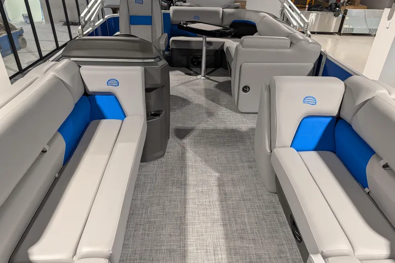 Slide: The Image of 2026 Sun Tracker Party Barge 20 DLX interior with gray and blue seating, modern design. - 75