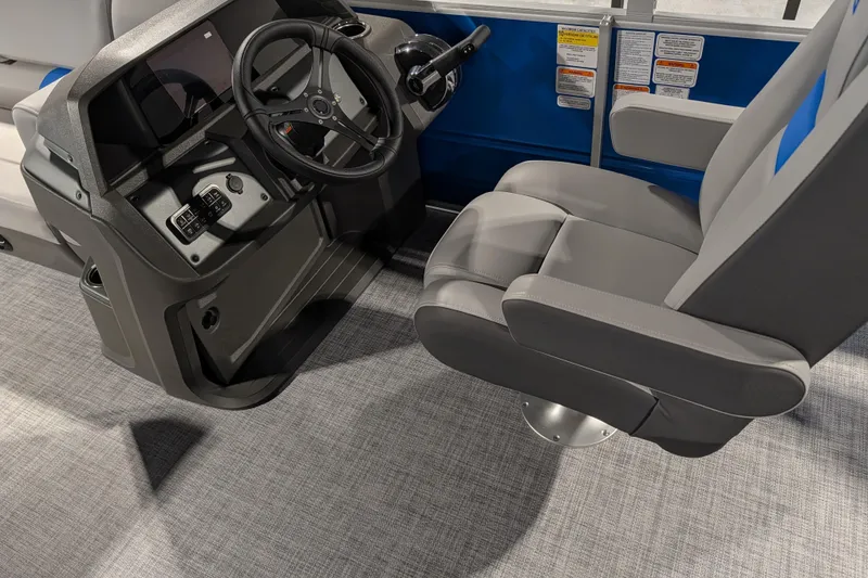 Slide: The Image of 2026 Sun Tracker Party Barge 20 DLX helm with steering wheel and captain's chair. - 76