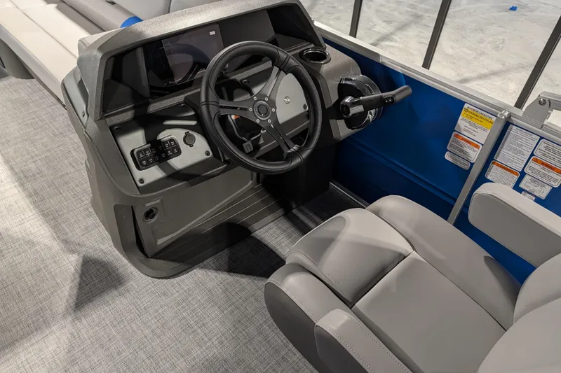 Slide: The Image of 2026 Sun Tracker Party Barge 20 DLX helm with steering wheel and controls. - 79