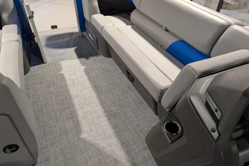 Slide: The Image of 2026 Sun Tracker Party Barge 20 DLX interior with gray seating and carpet. - 80