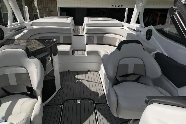 Slide: The Image of 2018 Rinker 29QX boat interior with luxurious seating and modern design. - 13