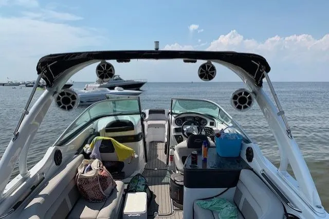 Slide: The Image of 2018 Rinker 29QX boat interior with seating, speakers, and ocean view. - 6