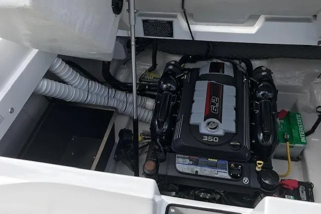 Slide: The Image of 2018 Rinker 29QX boat engine compartment with 6.2L 350 horsepower engine. - 21