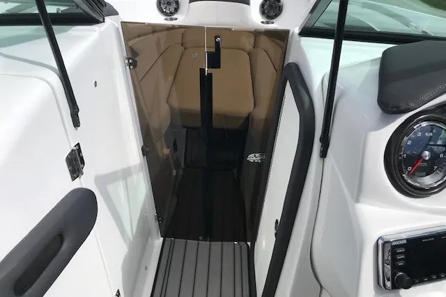 Slide: The Image of 2018 Rinker 29QX boat interior with cabin entrance and dashboard details. - 8
