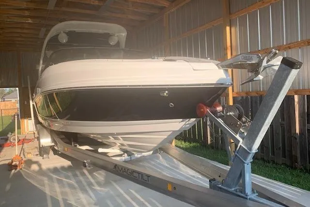 Slide: The Image of 2018 Rinker 29QX boat on trailer in covered storage. - 22