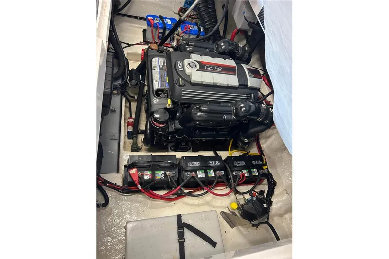 Slide: The Image of Engine compartment of a 2018 Rinker 29QX boat with visible batteries and wiring. - 20