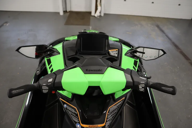 Slide: The Image of 2023 Kawasaki 310LX-S Ultra jet ski handlebars and dashboard in a garage setting. - 12