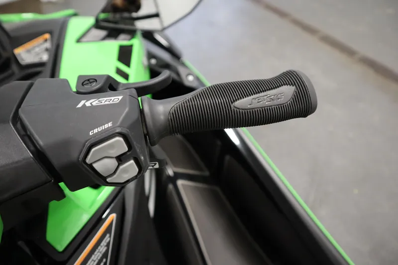 Slide: The Image of Close-up of 2023 Kawasaki 310LX-S Ultra handlebar with cruise control buttons. - 14