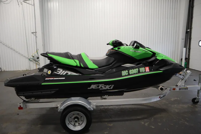 Slide: The Image of 2023 Kawasaki 310LX-S Ultra Jet Ski in green and black on a trailer. - 4
