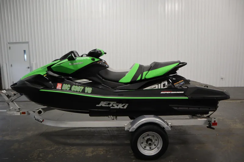 Slide: The Image of 2023 Kawasaki 310LX-S Ultra Jet Ski in green and black on a trailer indoors. - 8