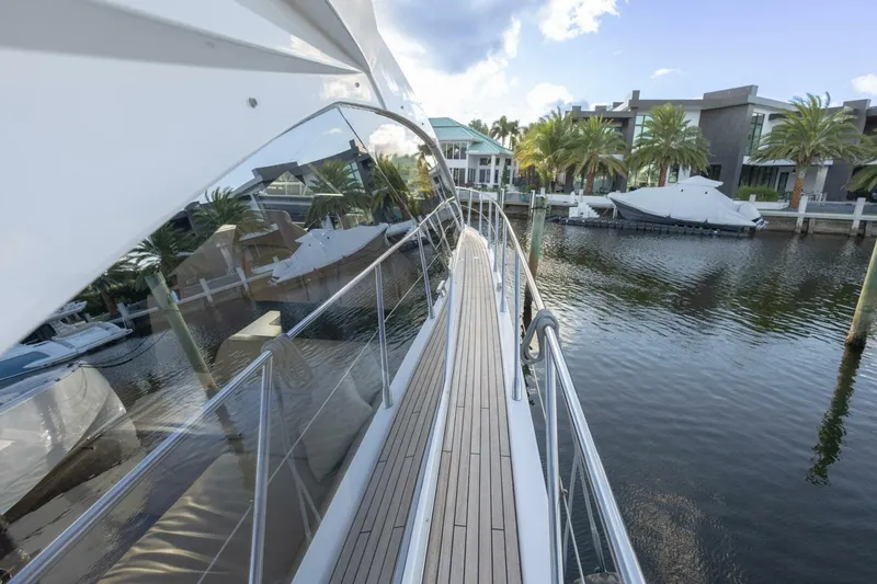 Slide: The Image of 2023 Azimut S6 Sport-Fly yacht docked by waterfront homes. - 11