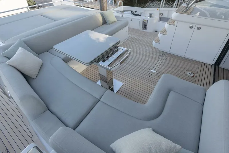 Slide: The Image of Luxurious seating area on 2023 Azimut S6 Sport-Fly yacht with elegant cushions and table. - 16