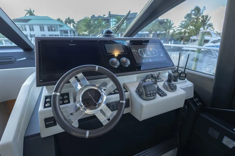 Slide: The Image of 2023 Azimut S6 Sport-Fly yacht helm with advanced navigation controls and sleek design. - 23