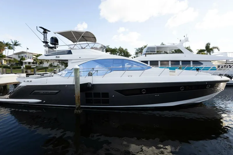 Slide: The Image of 2023 Azimut S6 Sport-Fly yacht docked in a marina, side view. - 3
