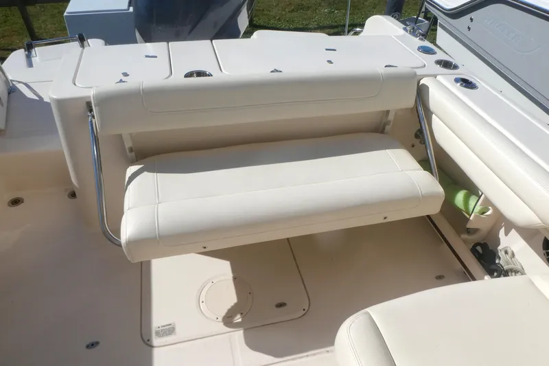 Slide: The Image of 2021 Grady-White Freedom 235 boat interior with white seating and stainless steel accents. - 10