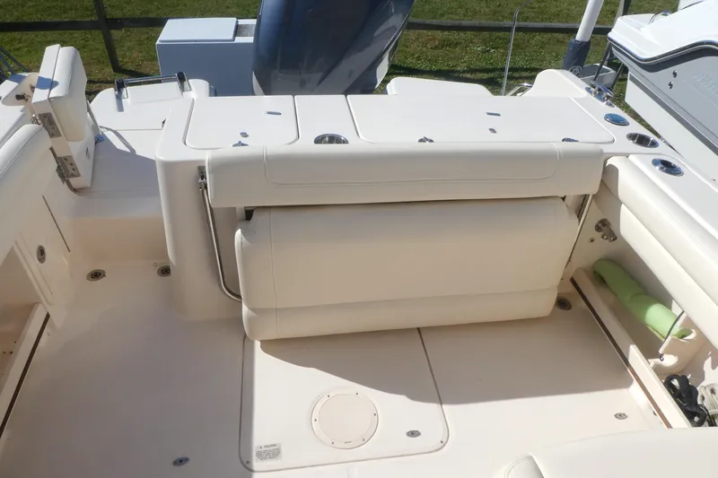 Slide: The Image of 2021 Grady-White Freedom 235 boat interior with seating and storage compartments. - 11