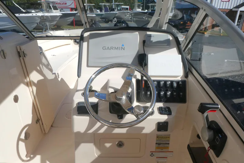 Slide: The Image of 2021 Grady-White Freedom 235 boat dashboard with Garmin navigation system. - 12