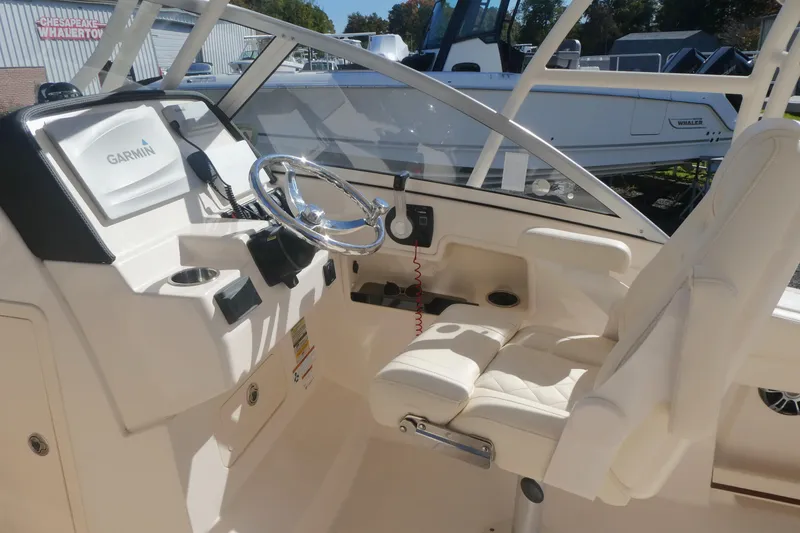 Slide: The Image of 2021 Grady-White Freedom 235 boat interior with Garmin navigation system and comfortable seating. - 13