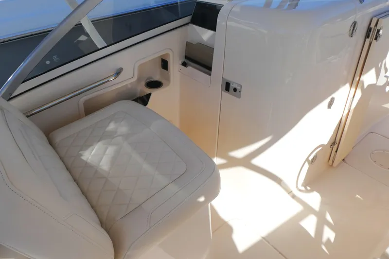 Slide: The Image of 2021 Grady-White Freedom 235 boat interior with white seating and sleek design. - 14
