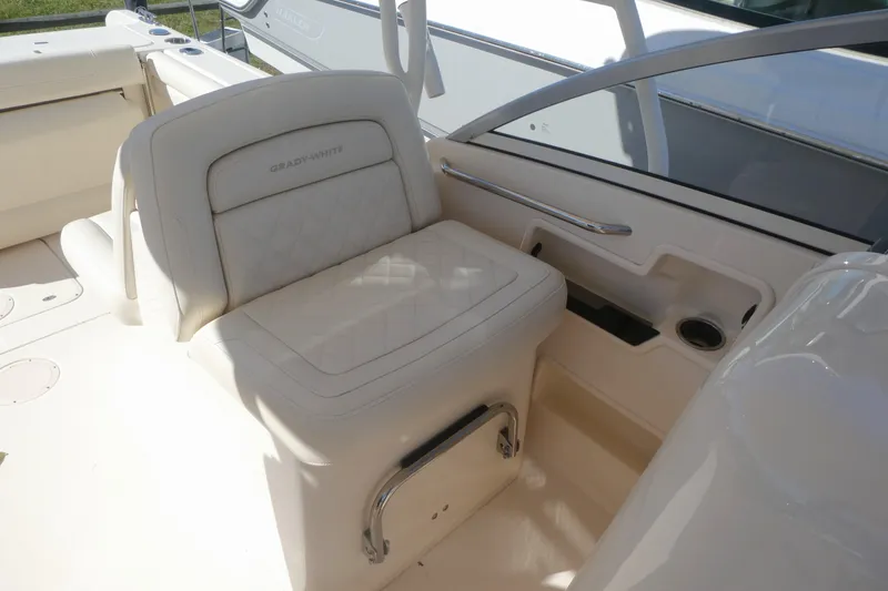 Slide: The Image of 2021 Grady-White Freedom 235 boat interior with cushioned seating and cup holder. - 15
