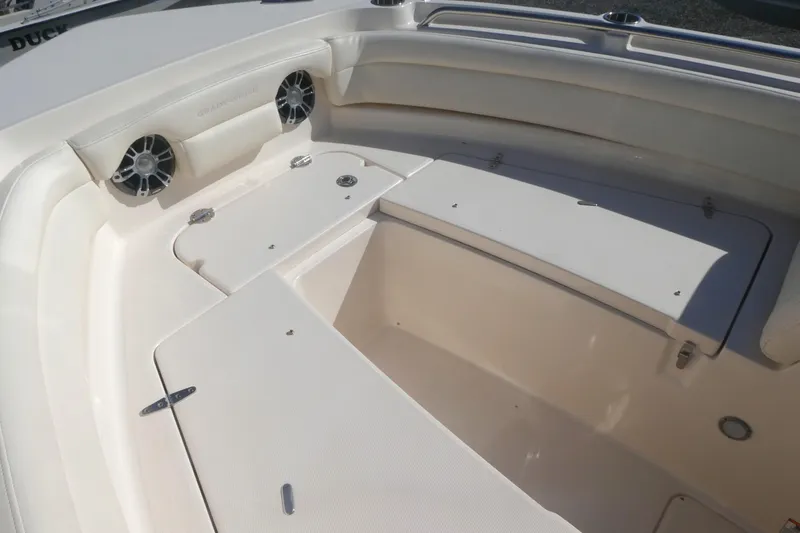Slide: The Image of 2021 Grady-White Freedom 235 boat interior with seating and storage compartments. - 17