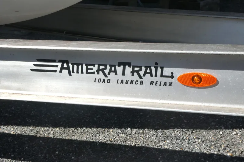 Slide: The Image of AmeraTrail trailer with logo and orange reflector, supporting 2021 Grady-White Freedom 235 boat. - 18