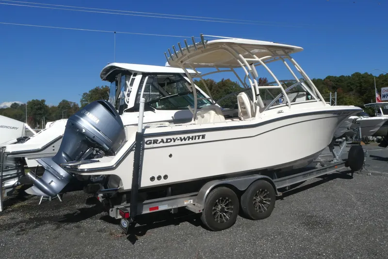 Slide: The Image of 2021 Grady-White Freedom 235 boat on trailer, featuring Yamaha outboard motor. - 2