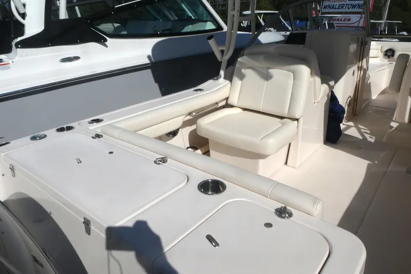 Slide: The Image of 2021 Grady-White Freedom 235 boat interior with seating and storage compartments. - 5