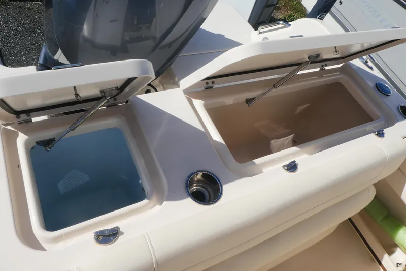 Slide: The Image of 2021 Grady-White Freedom 235 boat with open storage compartments. - 8