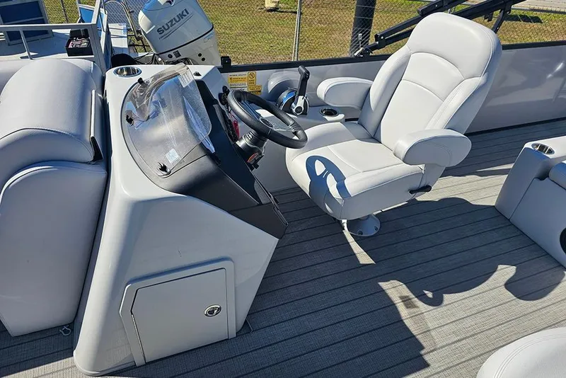 Slide: The Image of 2023 Bentley Pontoons 243 Legacy Swingback Sport3 helm with plush captain's chair and steering wheel. - 12