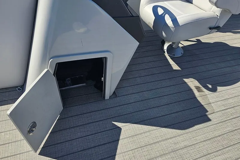 Slide: The Image of 2023 Bentley Pontoons 243 Legacy Swingback interior with open storage compartment and seating. - 13