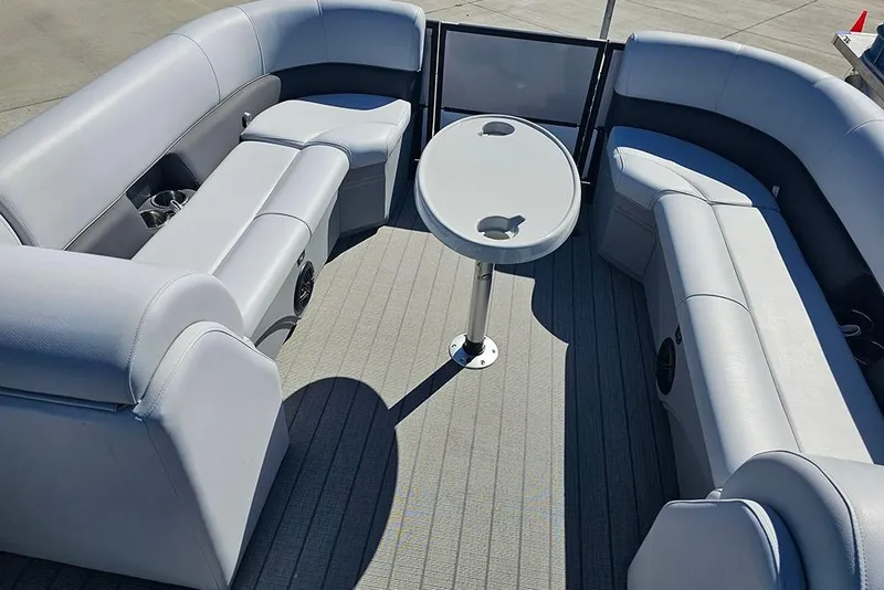 Slide: The Image of 2023 Bentley Pontoons 243 Legacy Swingback interior with gray seating and table. - 16