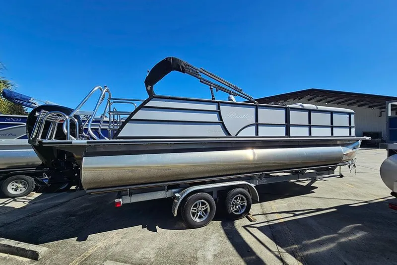 Slide: The Image of 2023 Bentley Pontoons 243 Legacy Swingback Sport3 on trailer under clear blue sky. - 4