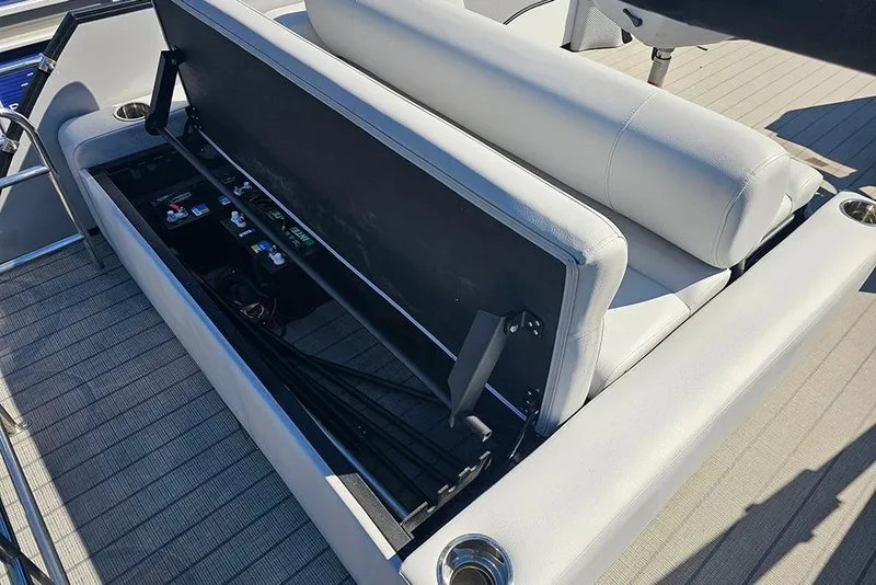 Slide: The Image of 2023 Bentley Pontoons 243 Legacy Swingback storage compartment with open seat revealing interior. - 9