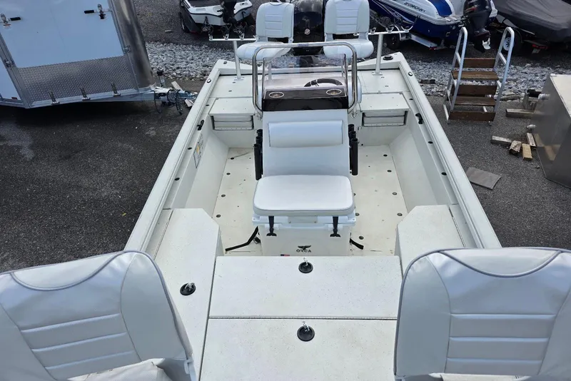 Slide: The Image of 2022 Ranger RB200 boat interior with white seating and steering console. - 11