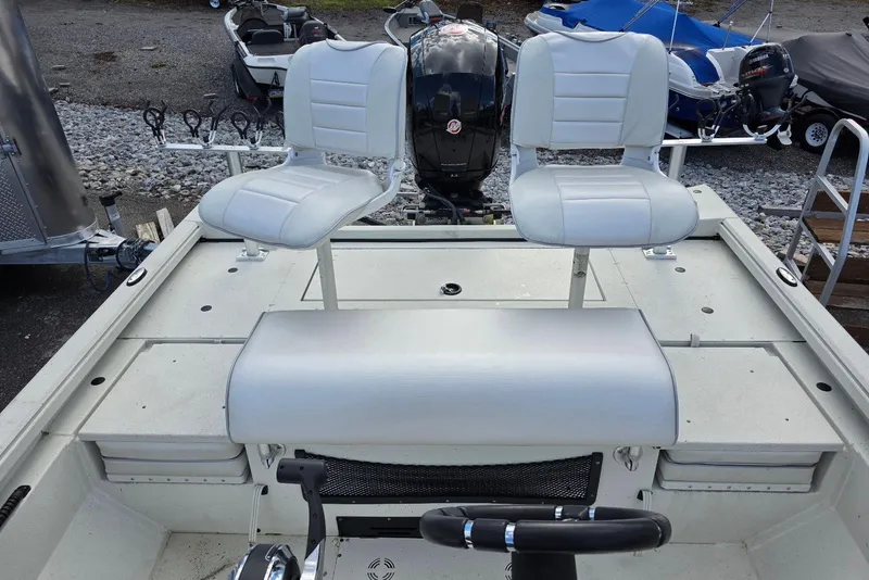 Slide: The Image of 2022 Ranger RB200 boat interior with dual white seats and steering wheel. - 13