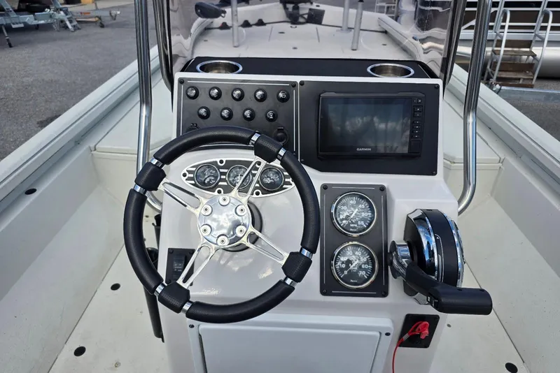 Slide: The Image of 2022 Ranger RB200 boat console with steering wheel, gauges, and navigation system. - 14