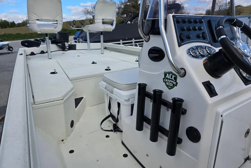 Slide: The Image of 2022 Ranger RB200 boat interior with steering console, rod holders, and seating. - 15