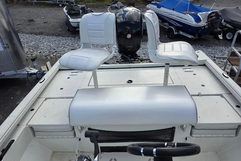 Slide: The Image of 2022 Ranger RB200 boat interior with white seats and steering wheel. - 16